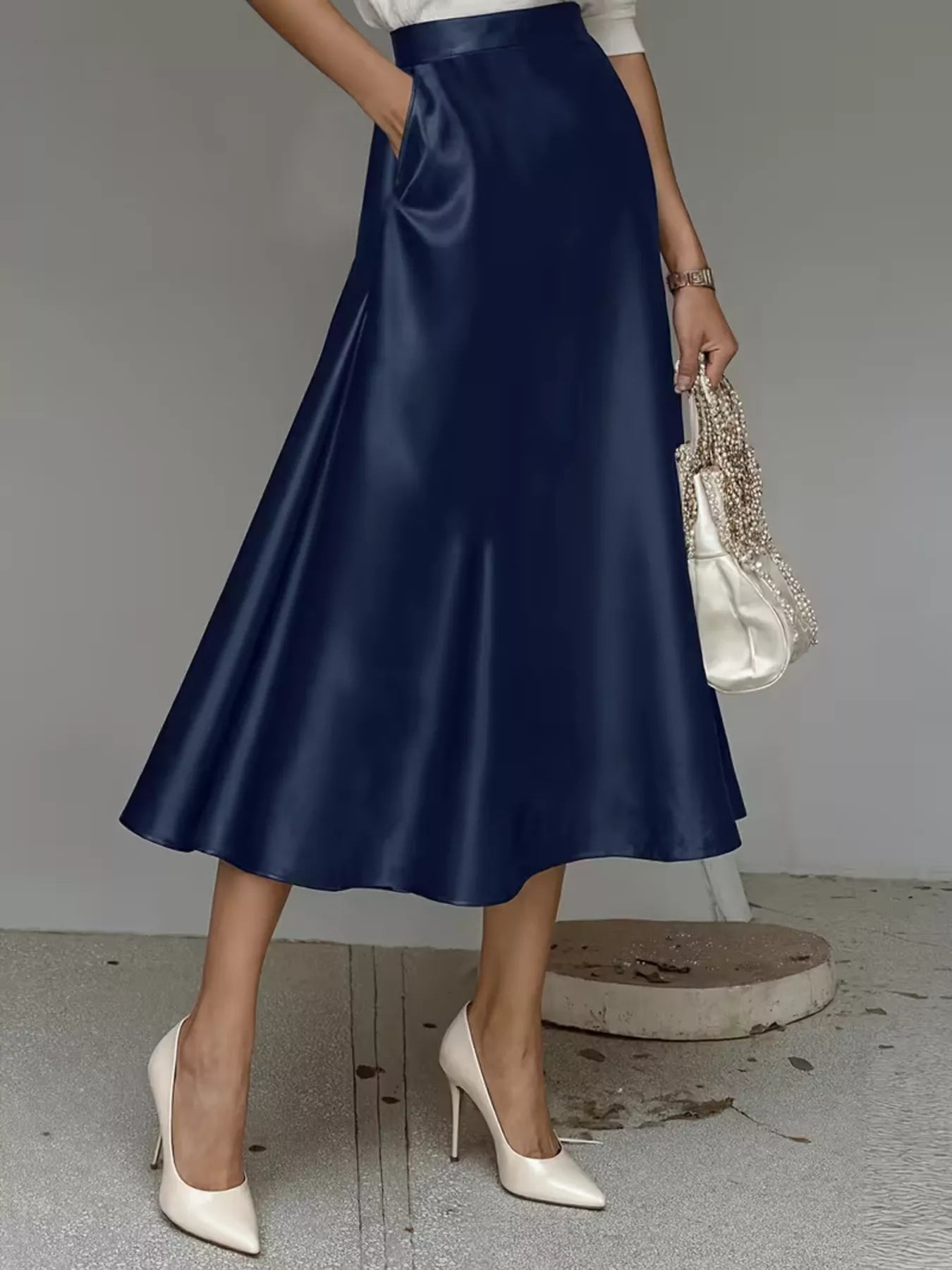 Navy satin midi skirt with smooth A-line flare and fitted waistband