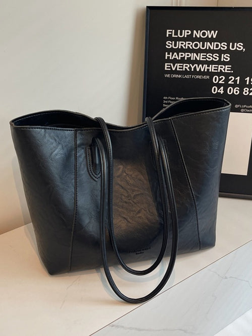 Classic leather tote bag, black with oval top handles and zip pocket at front